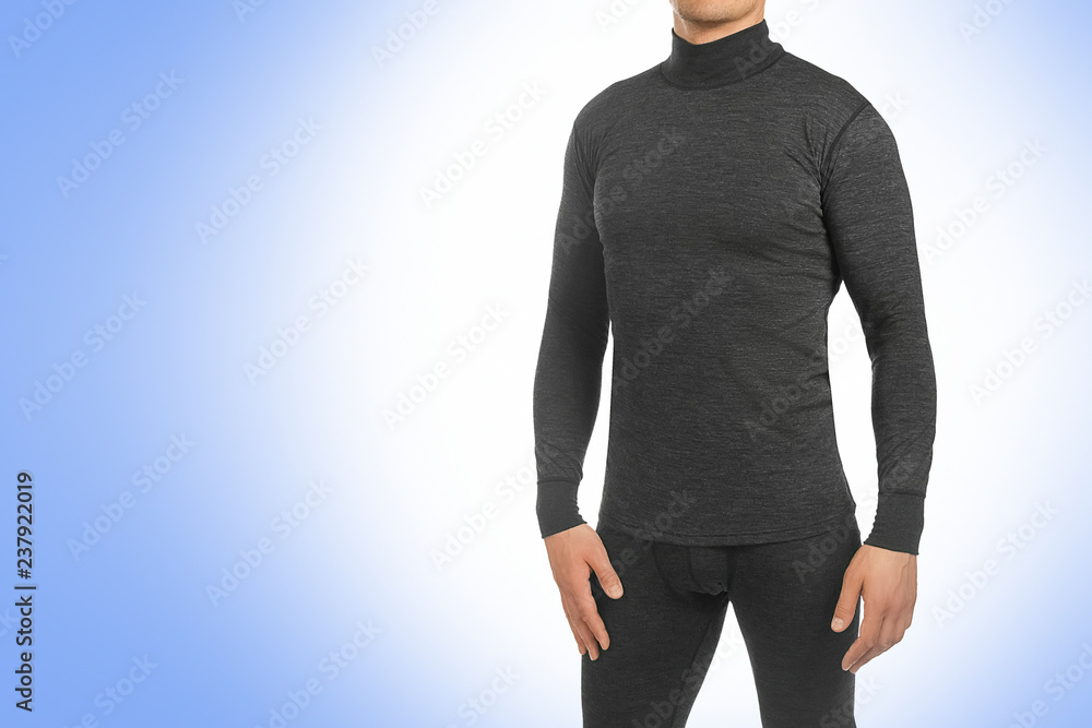 Man in thermal underwear for active winter sport. Man wearing Thermolinen isolated on blue background. T-shirt with long sleeves and leggings Man in thermal underwear for active winter sport. Man wearing Thermolinen isolated on blue background. T-shirt with long sleeves and leggings