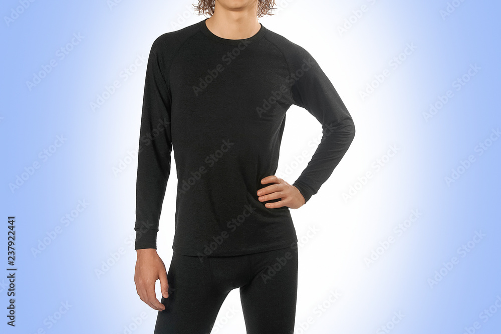 Man in thermal underwear for active winter sport. Man wearing Thermolinen isolated on blue background. T-shirt with long sleeves and leggings Man in thermal underwear for active winter sport. Man wearing Thermolinen isolated on blue background. T-shirt with long sleeves and leggings