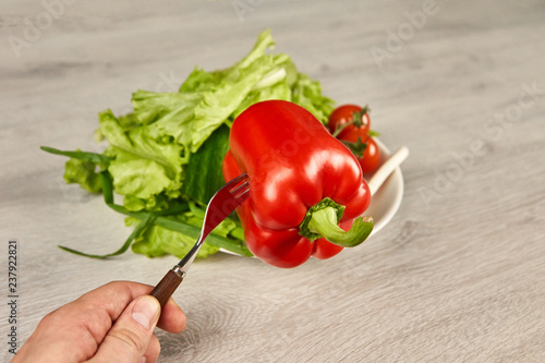Vegetables in a white plate on a wooden background