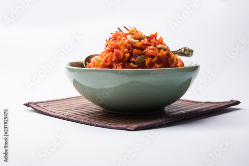 Gajar ka halwa is a carrot-based sweet dessert pudding from India. Garnished with Cashew/almond nuts. served in a bowl. photo