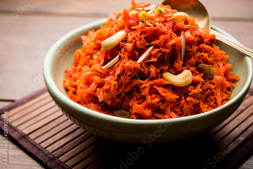 Gajar ka halwa is a carrot-based sweet dessert pudding from India. Garnished with Cashew/almond nuts. served in a bowl. photo