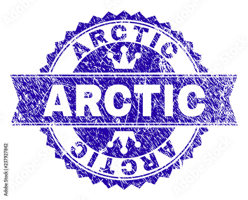 ARCTIC rosette stamp seal watermark with distress style. Designed with round rosette, ribbon and small crowns. Blue vector rubber watermark of ARCTIC label with unclean style.