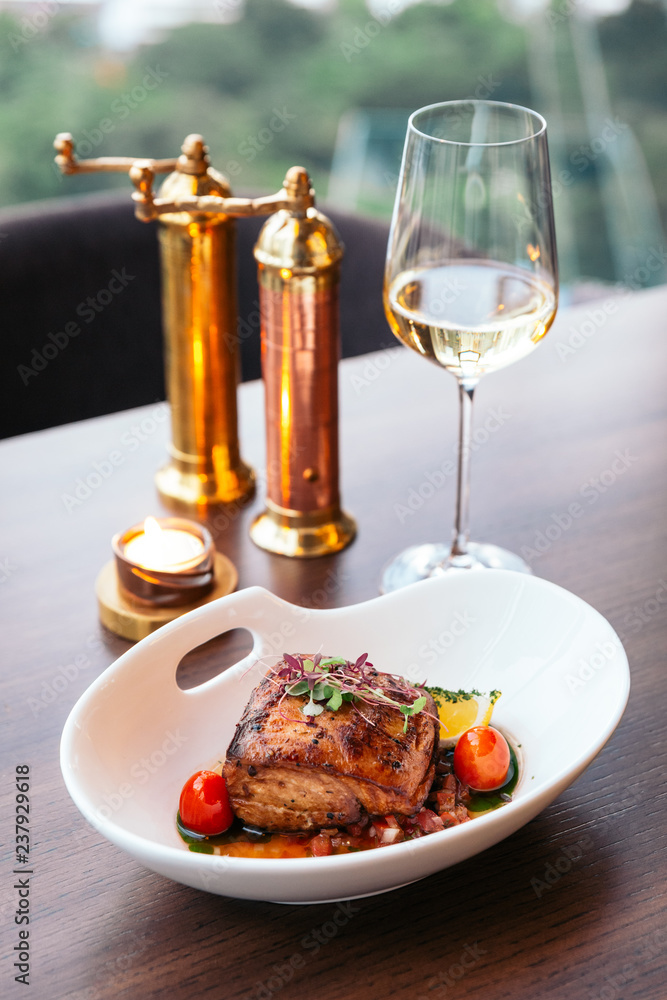 Baked juicy chicken breast and crispy skin with tomato and lemon served with white wine. Baked juicy chicken breast and crispy skin with tomato and lemon served with white wine.