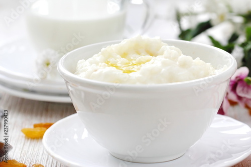 Sweet rice porridge with butter and mug of milk
