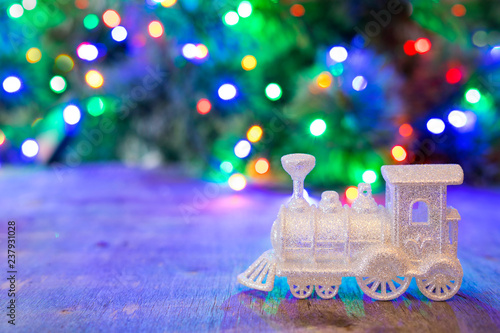 Silver Christmas train on a background of multi-colored bokeh.