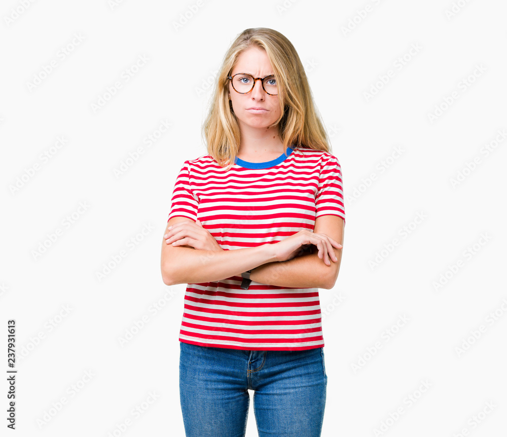 Beautiful young woman wearing glasses over isolated background skeptic and nervous, disapproving expression on face with crossed arms. Negative person. Beautiful young woman wearing glasses over isolated background skeptic and nervous, disapproving expression on face with crossed arms. Negative person.