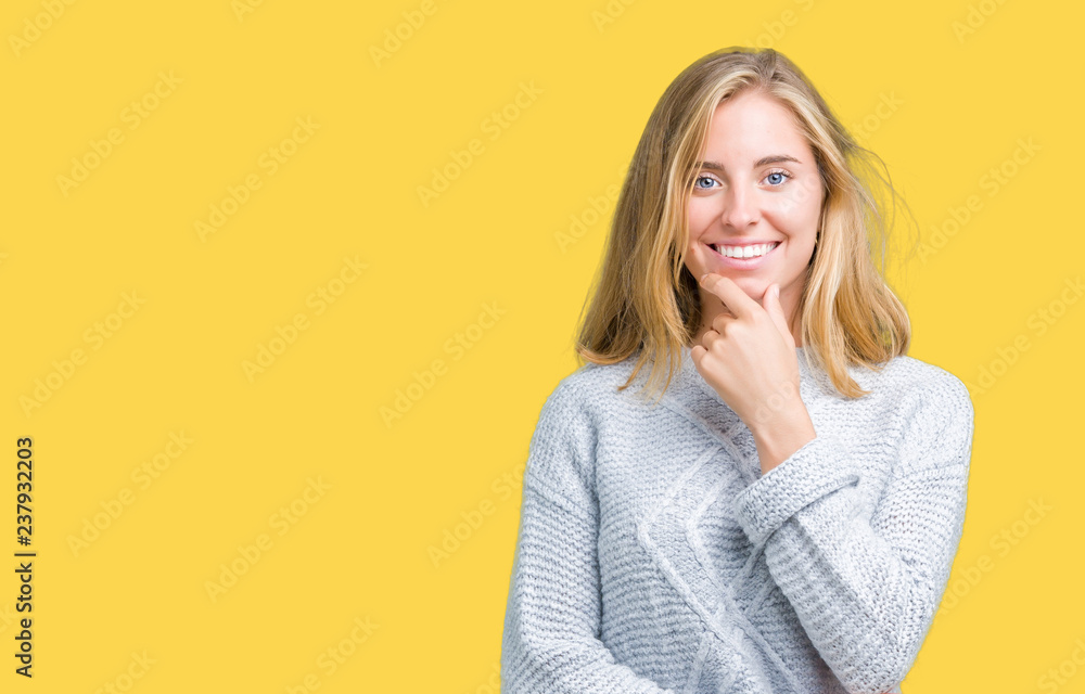 Beautiful young woman wearing winter sweater over isolated background looking confident at the camera with smile with crossed arms and hand raised on chin. Thinking positive. Beautiful young woman wearing winter sweater over isolated background looking confident at the camera with smile with crossed arms and hand raised on chin. Thinking positive.