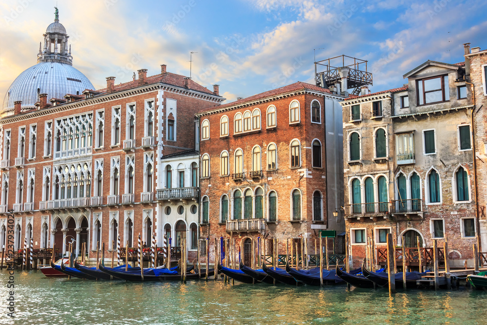 Gondolas of Venice in front of medieval palaces and the dome of 