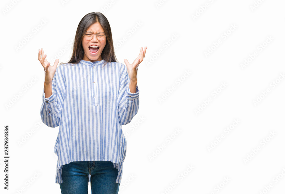 Young asian woman over isolated background crazy and mad shouting and yelling with aggressive expression and arms raised. Frustration concept. Young asian woman over isolated background crazy and mad shouting and yelling with aggressive expression and arms raised. Frustration concept.