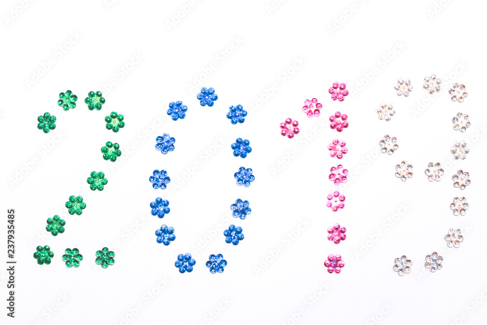 2019 lined with sequins on white background. Christmas composition. Top view, close-up 2019 lined with sequins on white background. Christmas composition. Top view, close-up