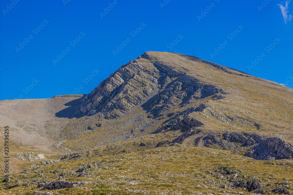 lonely mountain top nature panorama view in clear weather and empty blue sky background 