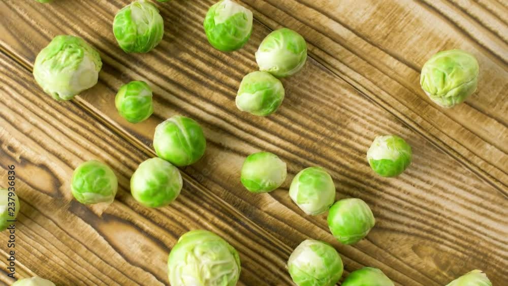 Fresh green brussels sprout vegetables on wood cooking surface. Close up 4k. Fresh green brussels sprout vegetables on wood cooking surface. Close up 4k.
