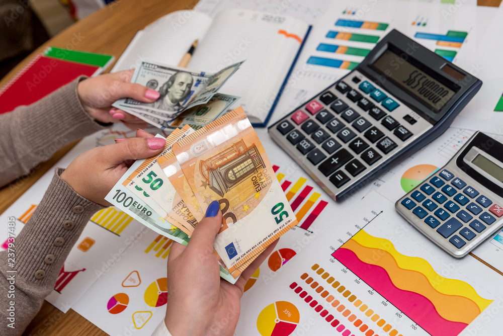 Fototapeta premium Female hands with dollar and euro exchanging with each other