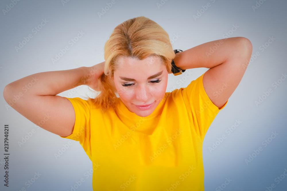 The girl in the yellow T-shirt straightens her white hair eyes closed. The girl in the yellow T-shirt straightens her white hair eyes closed.