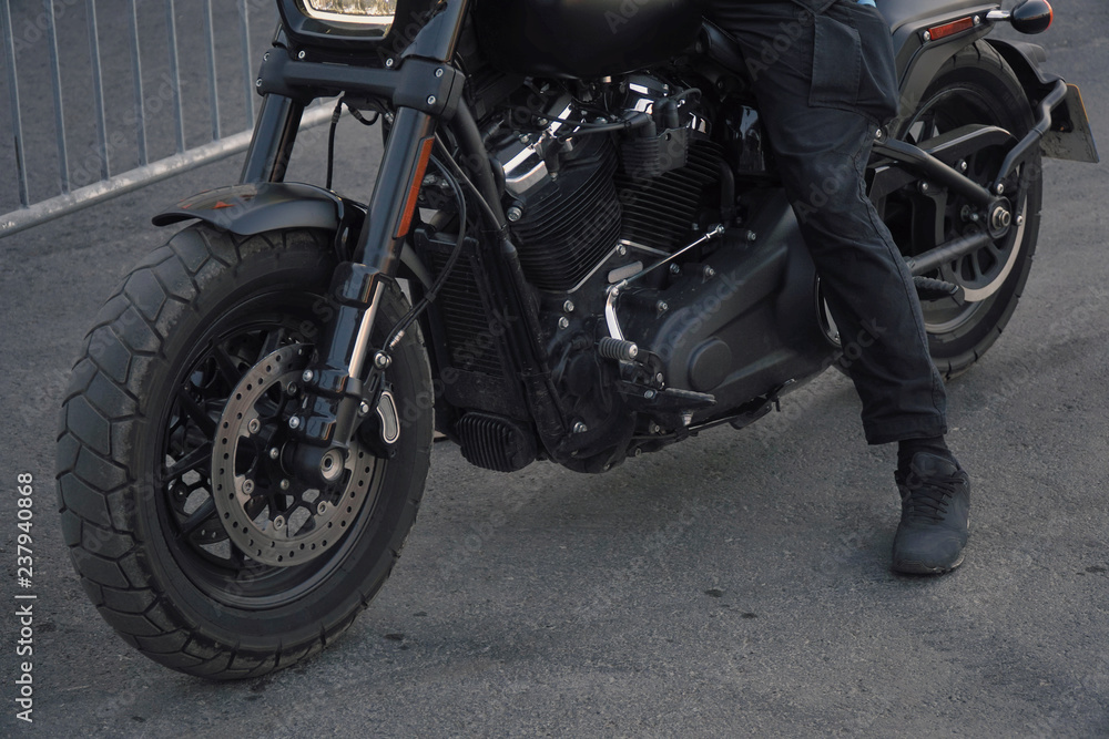 Biker in black clothes sitting on motorcycle Biker in black clothes sitting on motorcycle