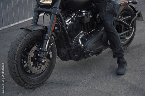 Biker in black clothes sitting on motorcycle