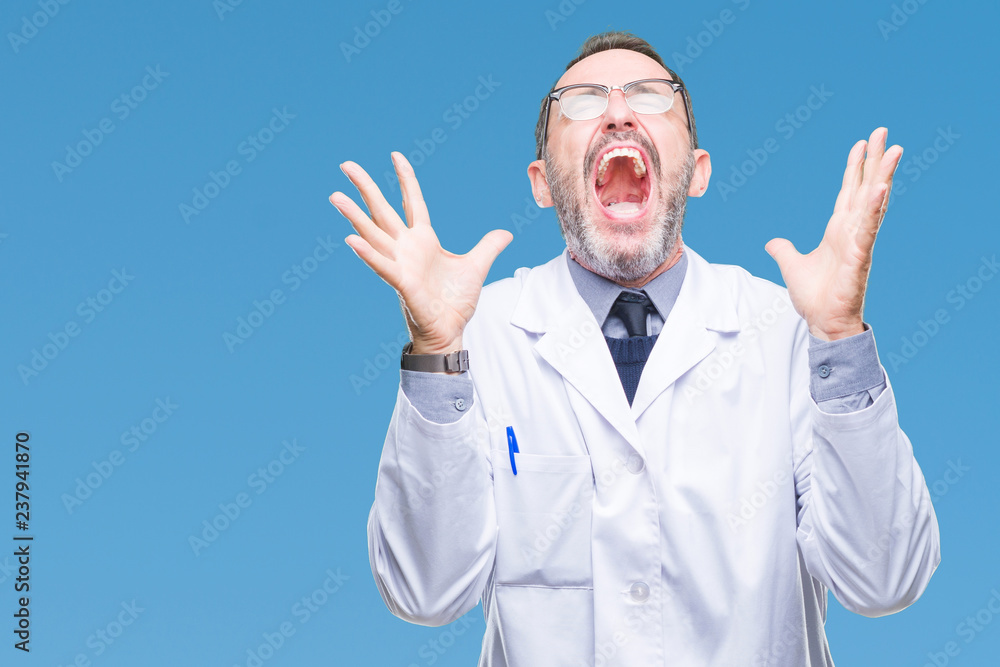 Middle age senior hoary professional man wearing white coat over isolated background celebrating mad and crazy for success with arms raised and closed eyes screaming excited. Winner concept Middle age senior hoary professional man wearing white coat over isolated background celebrating mad and crazy for success with arms raised and closed eyes screaming excited. Winner concept
