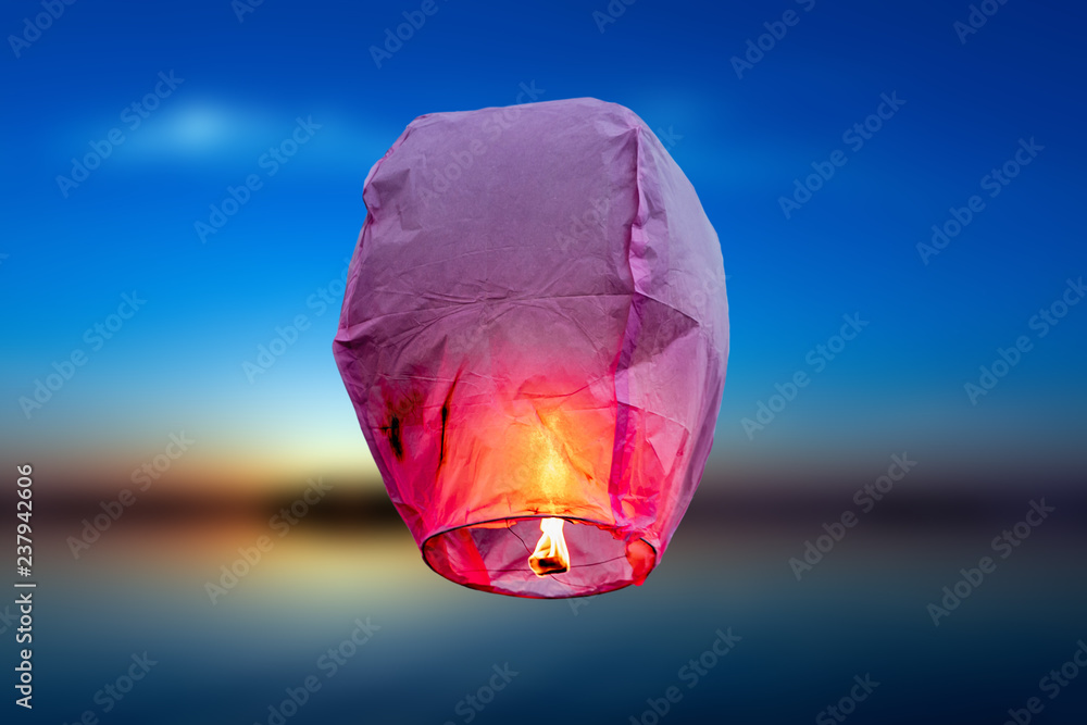 balloon fire Sky lantern flying lanterns, hot-air balloons Lantern flies up  highly in the sky. Sea blur backgrounds Stock Photo | Adobe Stock