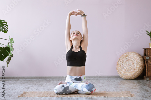 Fitness woman practices yoga asana parvatasana