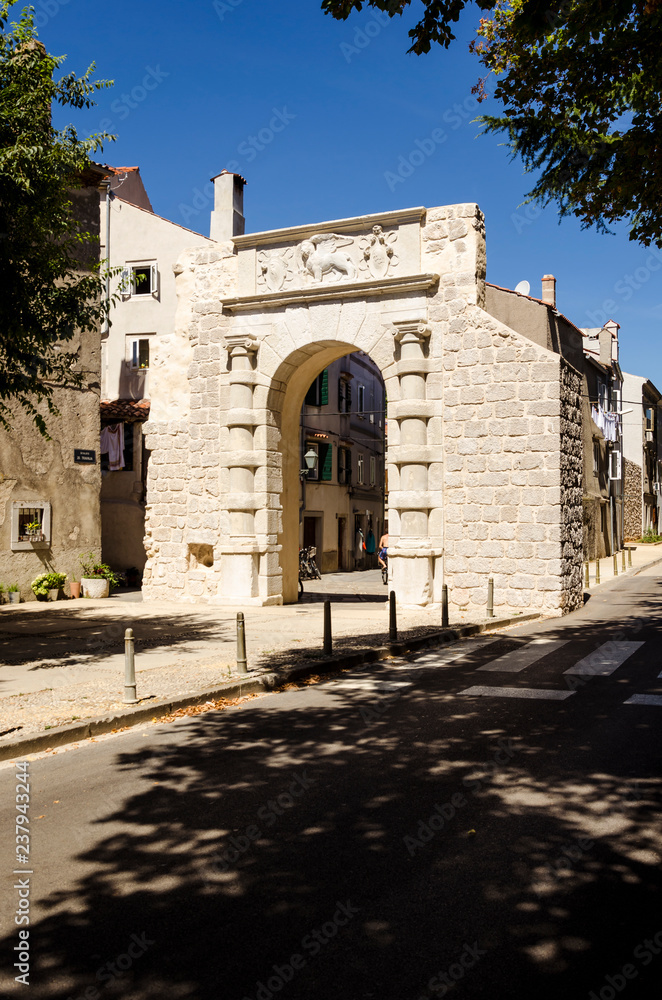 the venetian arch in cres, view of the ancient venetian arch in crez, croatia. symbol of the history of venice and of istria