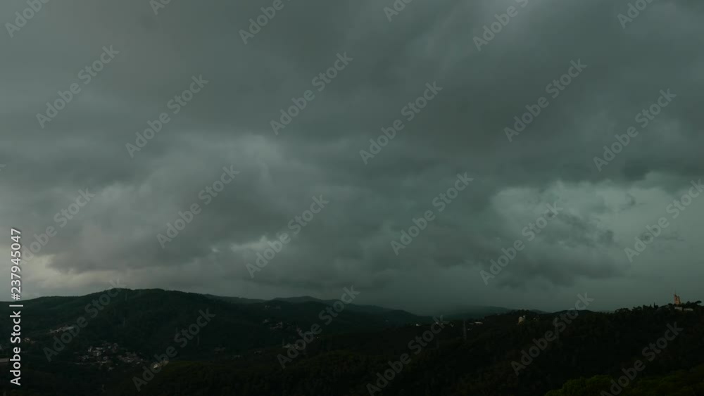 Heavy dark clouds over green mountains, before storm Heavy dark clouds over green mountains, before storm