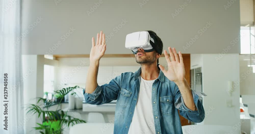 Portrait of handsome man using vr glasses in living room in slow motion. Portrait of handsome man using vr glasses in living room in slow motion.