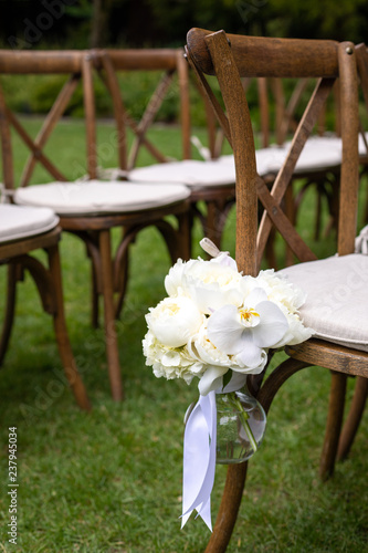 Bouquet hanging on a row of chairs, with space for text on top and bottom