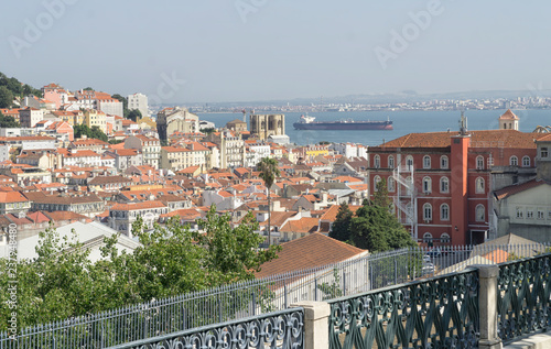 Cityscape Lisbon, Portugal, with The Lisbon Cathedral, Tagus River. Sunny summer day, blue sky. photo