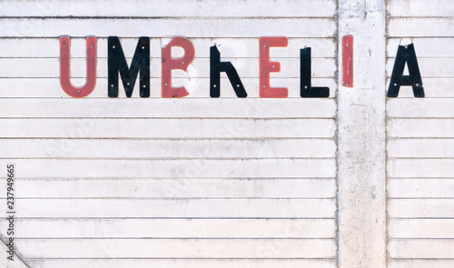 Old white dirty wooden boards, with red and black letters, Umbrella