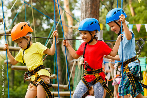 Photos Children - a boy and a girl in the rope park pass obstacles