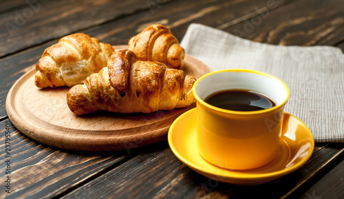 mug of coffee  croissants on wooden background
