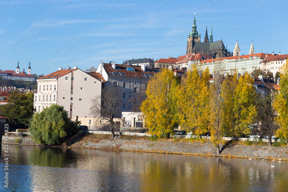 Fototapeta premium Colorful autumn Prague gothic Castle with the Lesser Town above River Vltava in the sunny Day, Czech Republic