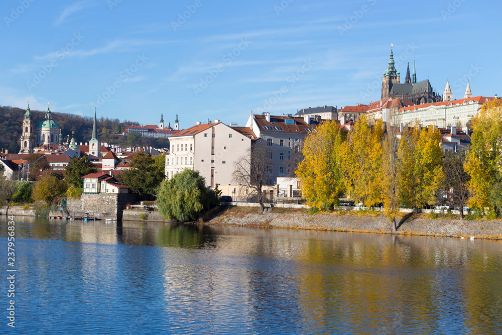 Fototapeta premium Colorful autumn Prague gothic Castle with the Lesser Town above River Vltava in the sunny Day, Czech Republic