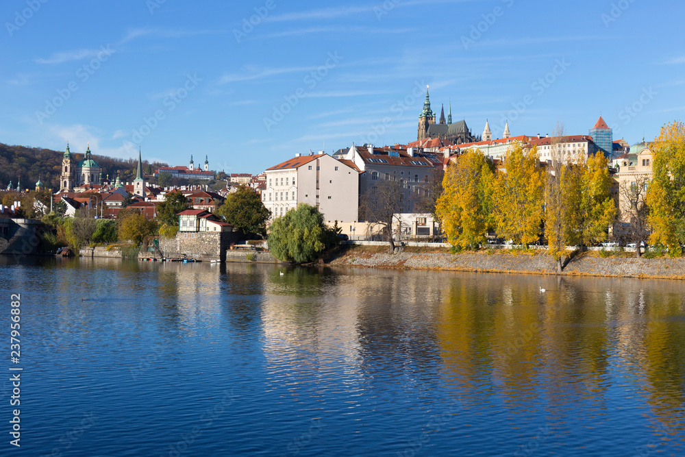 Fototapeta premium Colorful autumn Prague gothic Castle with the Lesser Town above River Vltava in the sunny Day, Czech Republic