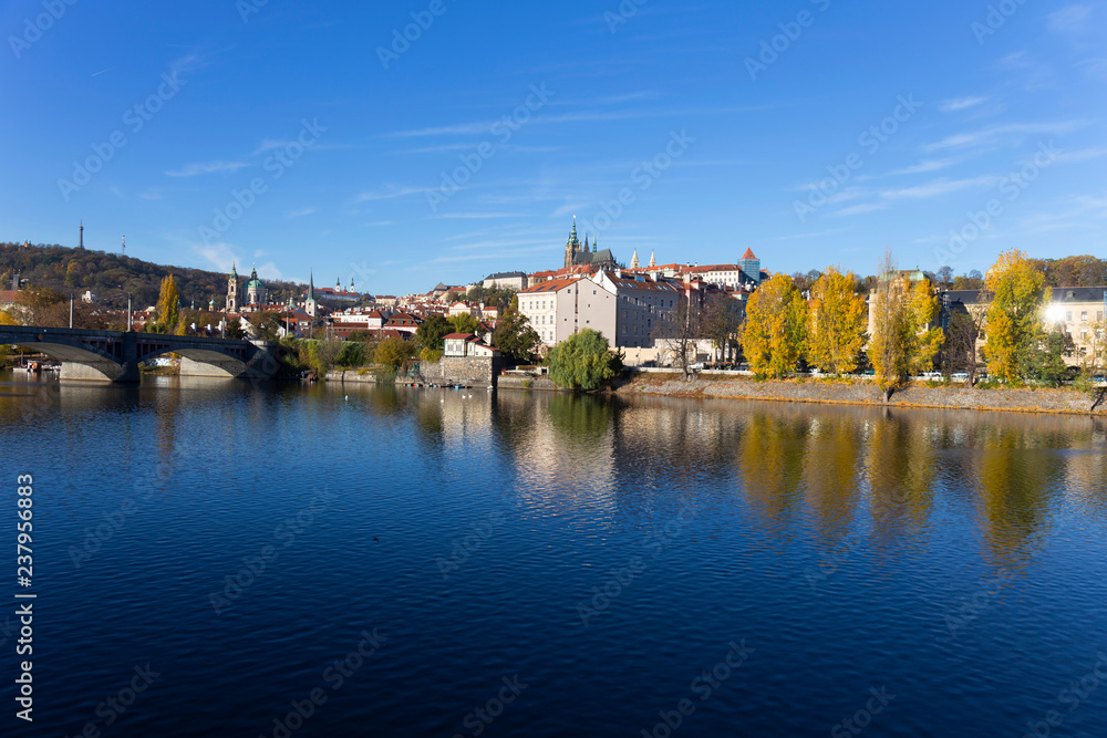 Colorful autumn Prague gothic Castle with the Lesser Town above River Vltava in the sunny Day, Czech Republic