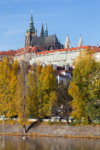 Colorful autumn Prague gothic Castle with the Lesser Town above River Vltava in the sunny Day, Czech Republic