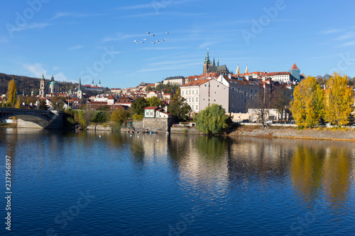 Colorful autumn Prague gothic Castle with the Lesser Town above River Vltava in the sunny Day, Czech Republic