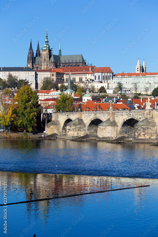 Obraz premium Colorful autumn Prague gothic Castle and Charles Bridge with the Lesser Town in the sunny Day, Czech Republic