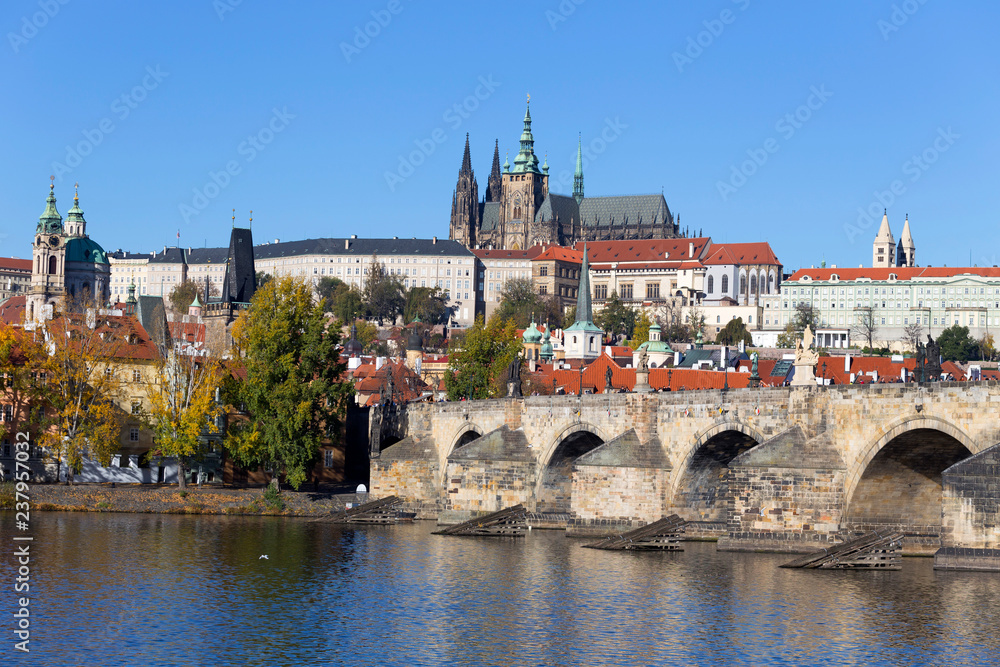 Colorful autumn Prague gothic Castle and Charles Bridge with the Lesser Town in the sunny Day, Czech Republic