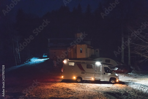 Night camping wtih camper van caravan in holiday outdoor adventure trip on the mountain. Nomad traveler camper van life