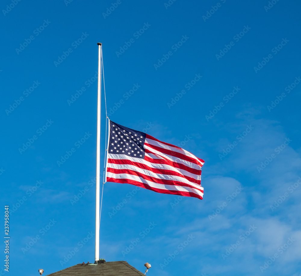 American flag flying at half staff