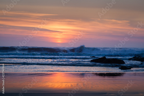 Waves Break as Sun sets on Beach