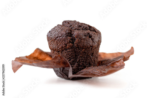 Delicious chocolate muffin in parchment isolated on white background