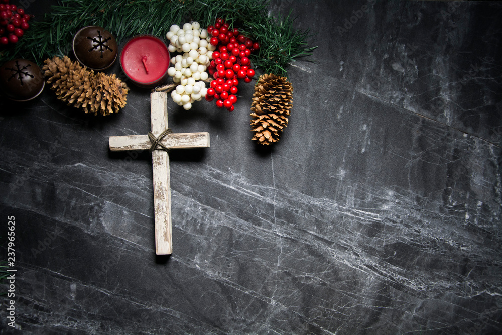 cross on black background with berries and pinecones Stock Photo