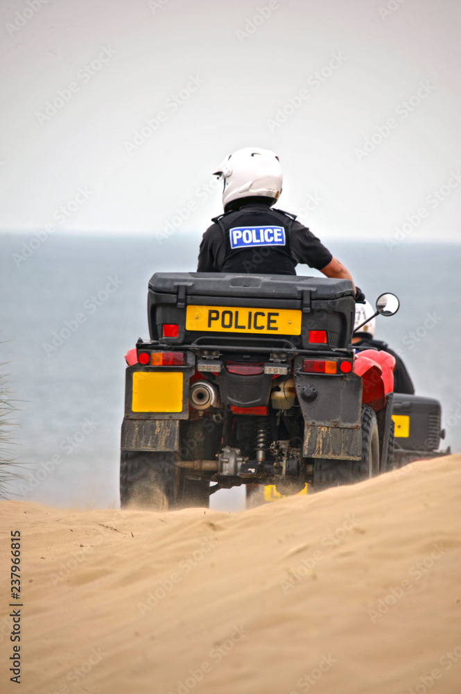 British Police on quads on the sand dunes of Formby, United Kingdom British Police on quads on the sand dunes of Formby, United Kingdom
