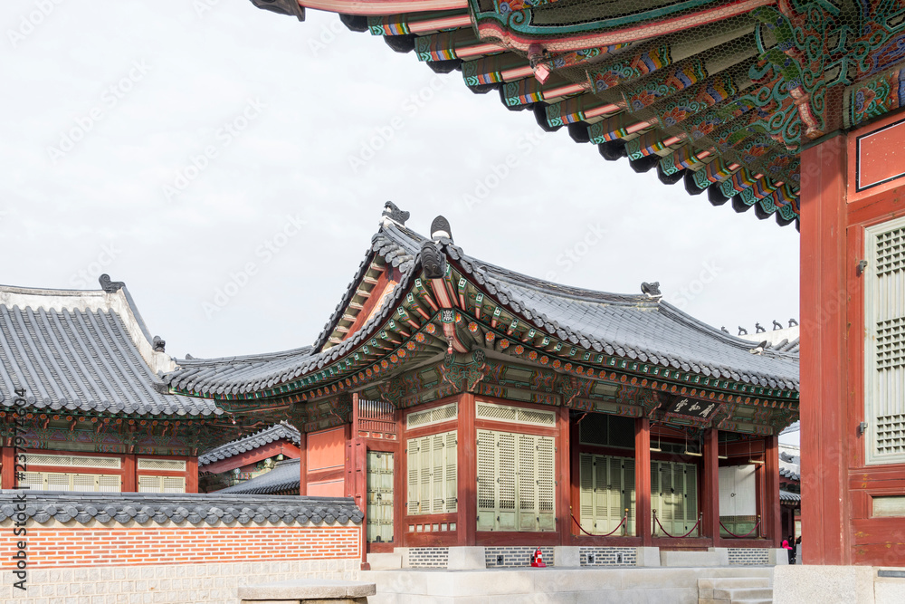 Fototapeta premium Architectural detail - Korean Tradition red wooden pole and outdoor stone wall, decoration brick wall and