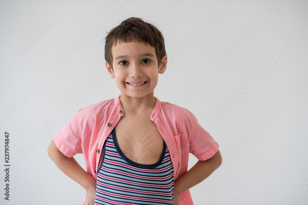 lilittle boy looking at heart love symbol sketched on his chest lilittle boy looking at heart love symbol sketched on his chest
