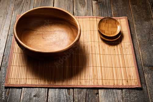 Empty wooden bowl on natural background