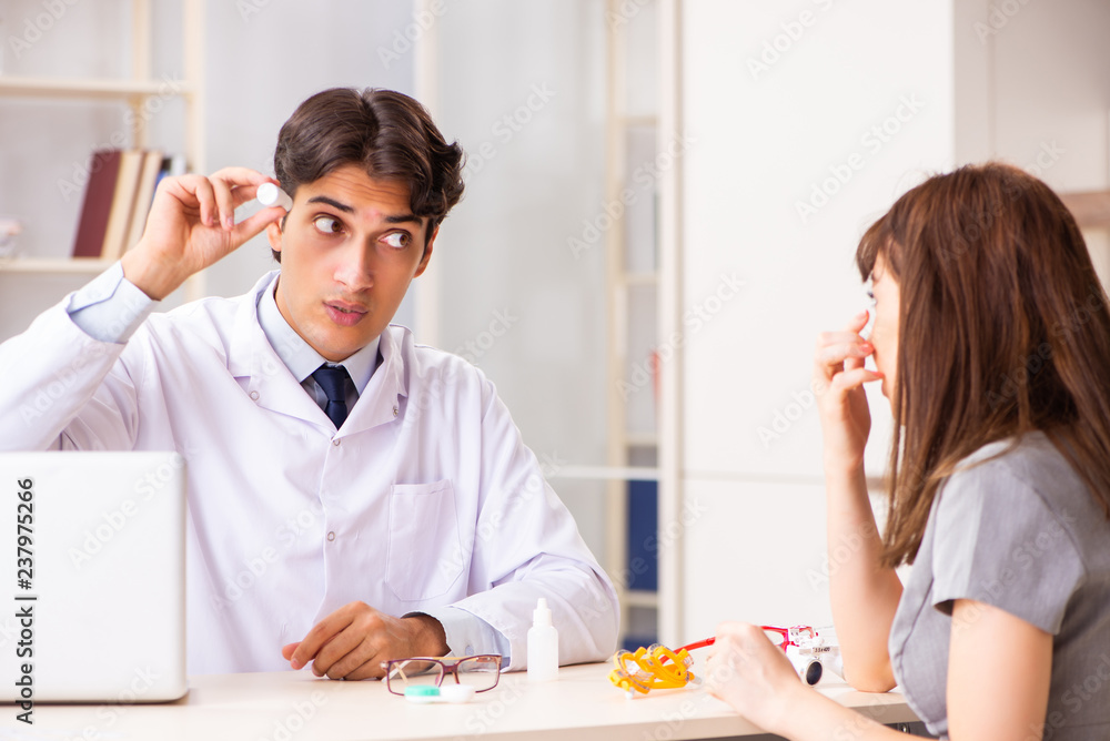 Young woman visiting male doctor ophthalmologist in hospital Young woman visiting male doctor ophthalmologist in hospital