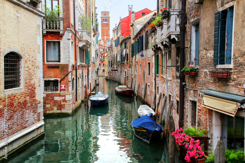 Houses and boats along narrow canal in Venice, Italy